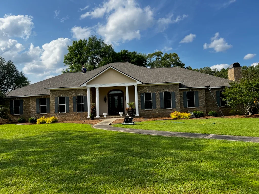 Finished shingle roof on a large brick home