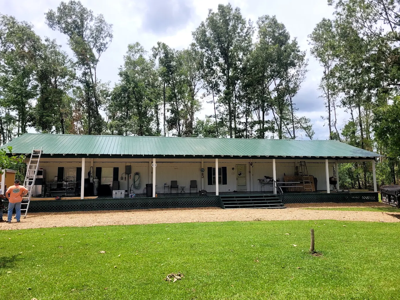 Long green metal roof on a rural home