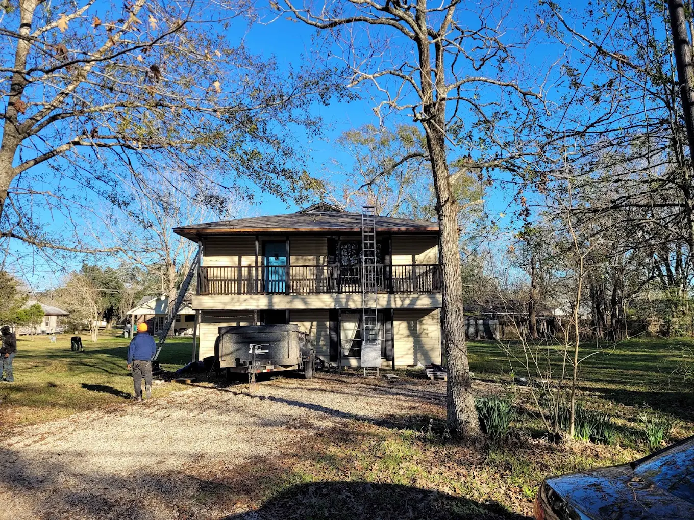 Roofing worksite at a two-story rural home